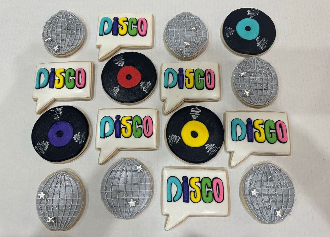 Silver luster disco-ball cookies, colorful record cookies and bubble-letter DISCO plaques