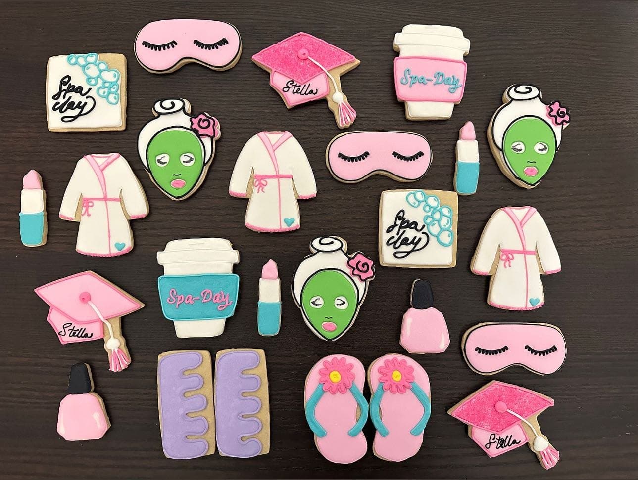 Pink and white spa cookies: face masks, robes, sleep masks, nail polish, flip-flops and graduation caps