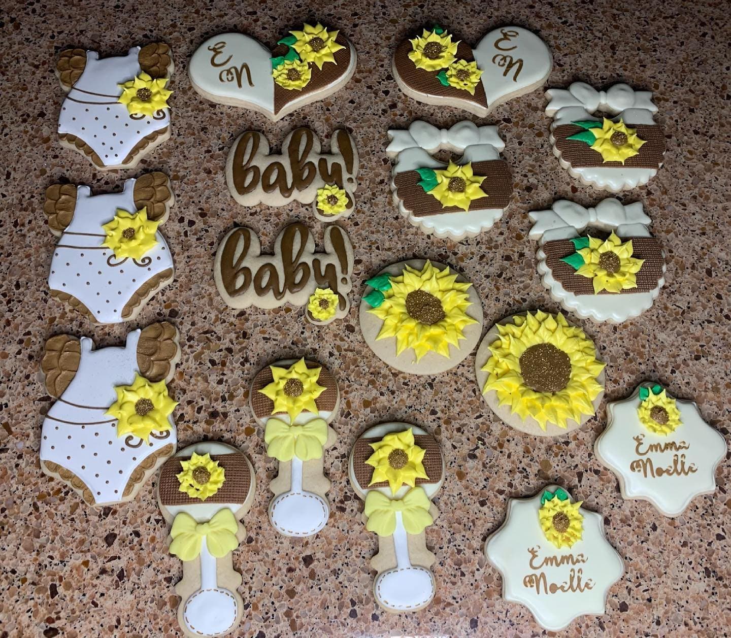 Sunflower, onesie, bottle and baby script cookies in yellow, white and brown