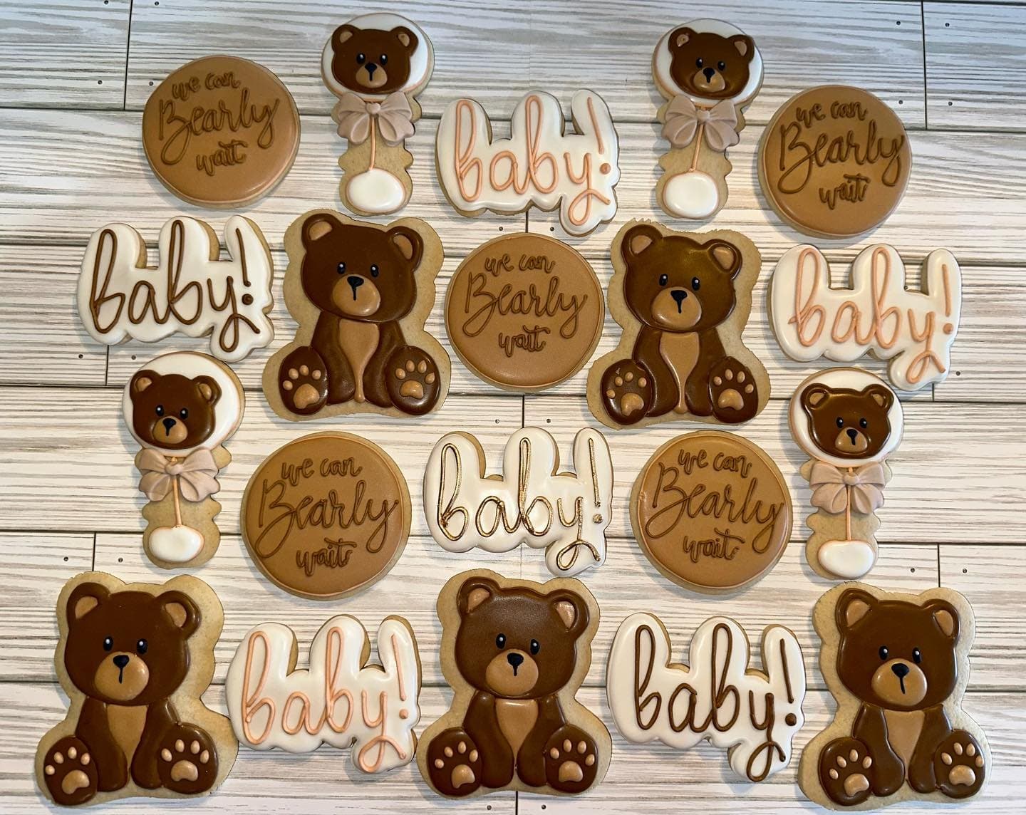 Brown teddy bear cookies with baby script plaques and round cookies reading we can bearly wait